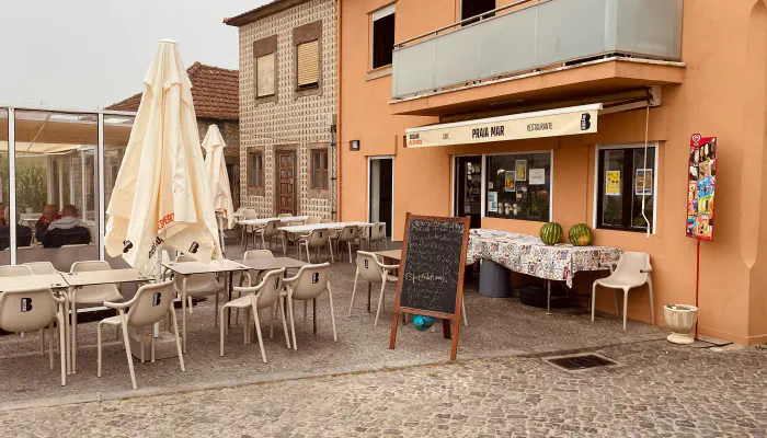 Grilled fish being cooked over charcoal outside Café Praia Mar in Vila Chã